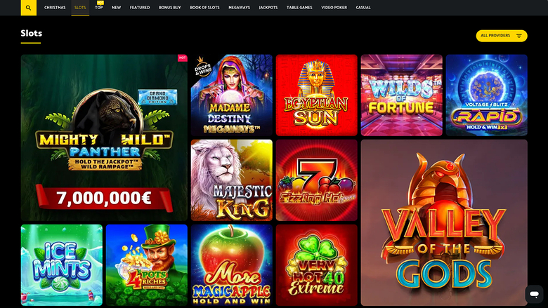 A slots lobby page of an online casino showing a grid of game tiles with a large featured jackpot game and a top category menu.