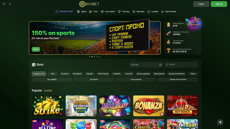 A dark-themed online casino lobby for RIOBET showing a sports bonus hero banner, a slots filter bar and a grid of game tiles.